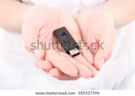 young woman hands holding black flash drive