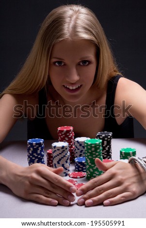 young beautiful blond woman with poker chips in casino