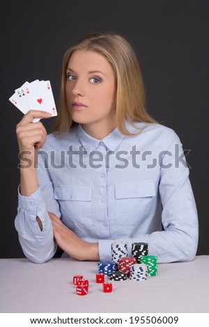 young beautiful blond woman playing poker in casino
