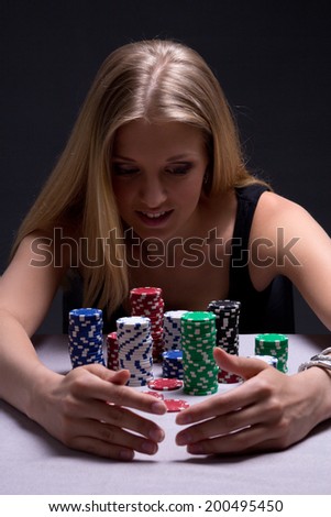 young beautiful blond woman with chips in casino