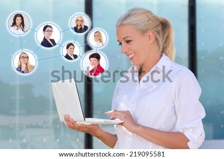 social network concept - attractive business woman with laptop in the street