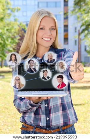 social network concept - beautiful smiling woman with laptop thumbs up in park