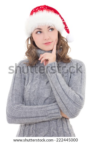 thoughtful beautiful woman in winter clothes and santa hat dreaming isolated on white background