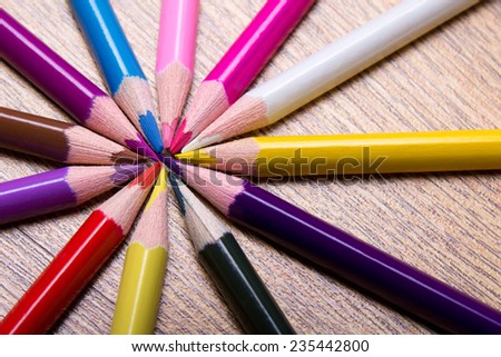 colored drawing pencils on wooden table background