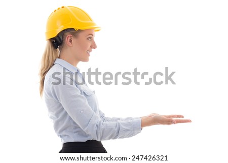 side view of business woman in builder helmet holding something isolated on white background