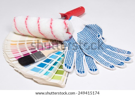 painter\'s tools - brushes, work gloves and colorful palette over white background