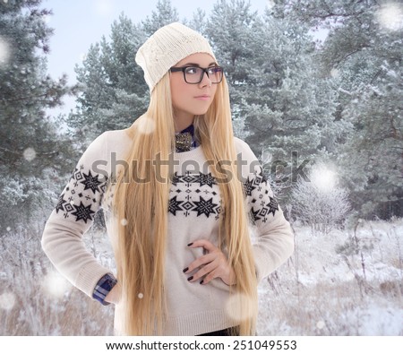 young attractive woman in winter clothes walking in forest