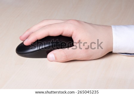 male hand with computer mouse on table