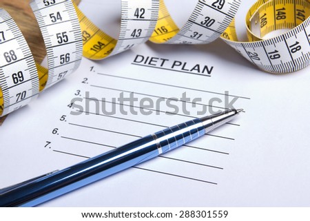 paper with diet plan, pen and yellow measure tape