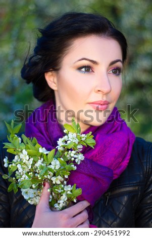 close up portrait of young beautiful woman with cherry tree flowers