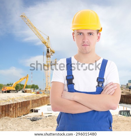 young handsome man in builder uniform at construction site