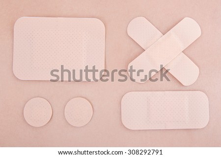 close up of different medical adhesive plasters on skin background