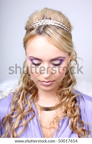 stock-photo-young-blonde-in-violet-with-curly-hair-50017654.jpg