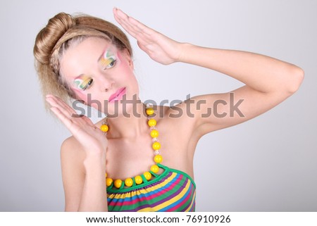 Young woman in dress with creative make-up and coiffure