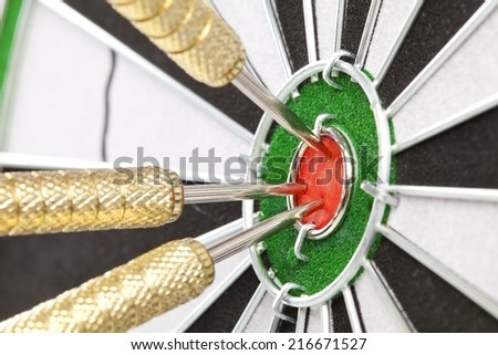 dart board sisal with darts in bullseye