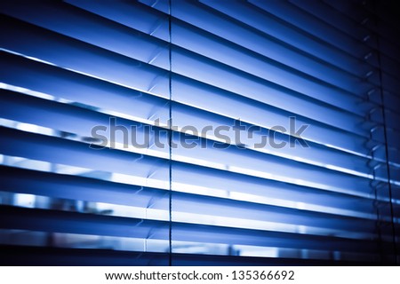 Blue venetian blinds reluxa shader in the office