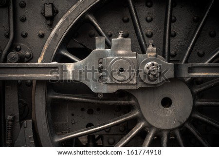 Old steam engine train wheels and parts close-up
