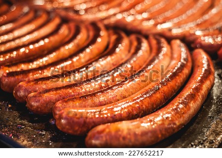 Red baked delicious juicy sausages in row