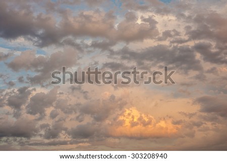Beautiful dreamy fluffy peach summer clouds on the sky background image