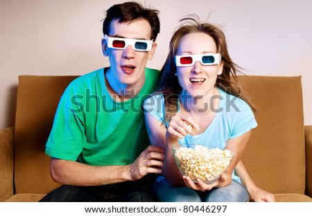 Couple watching movie through 3d glasses