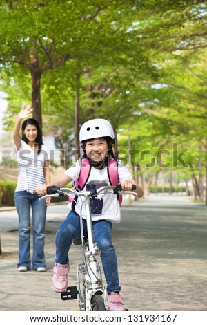 happy little girl riding bicycle go to school