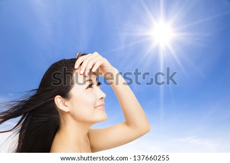 beautiful young woman with sunlight background. summer skin care concept