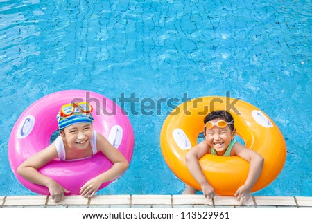 happy children having fun  in the swimming pool