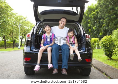 happy family sitting in the car