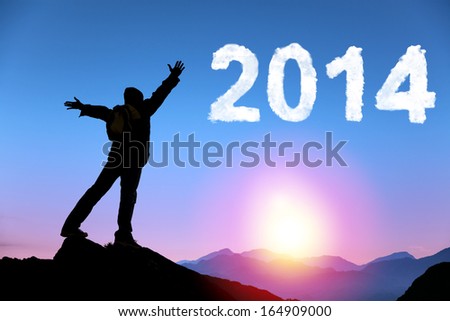 Happy New Year 2014.Happy Young Man Standing On The Top Of Mountain