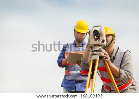 Surveyor engineer making measure with tablet pc