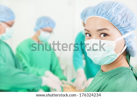 Woman surgeon working with team in a surgical room