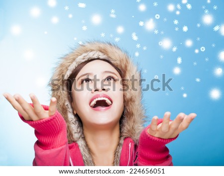 happy young woman watching winter snow