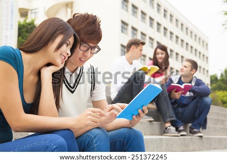 young couple student watching  the book