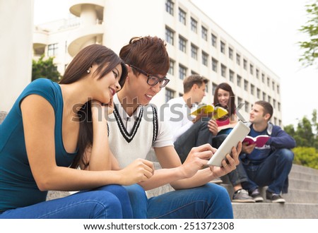young couple student using the tablet