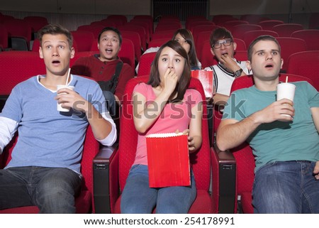 Young people  watching a movie at the cinema