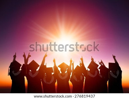 silhouette of Students Celebrating Graduation watching the sunlight