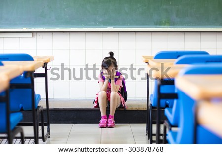stress  girl sitting and  thinking on the classroom floor