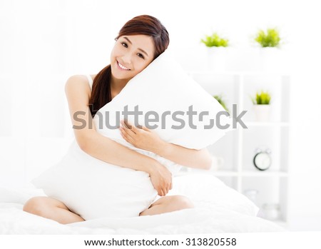 smiling young asian woman  on the bed