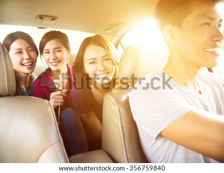 young group people enjoying road trip in the car