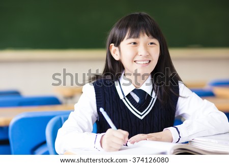 happy pretty  student girl with books in classroom