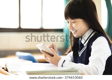 happy  student girl with smart phone in classroom