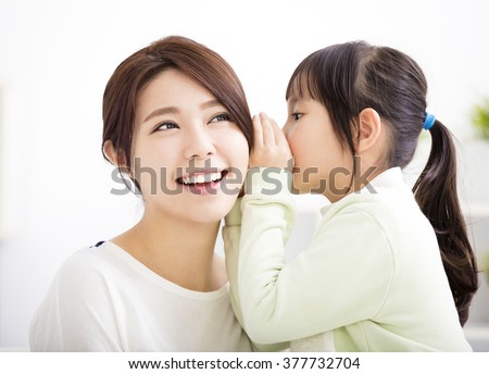 mother and daughter whispering gossip