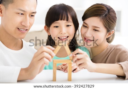 happy family playing with toy blocks