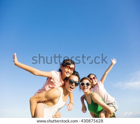 happy family having fun outdoors against blue sky background
