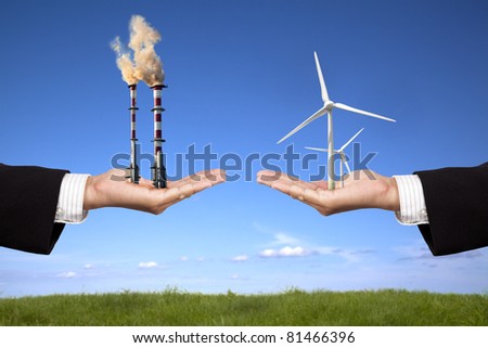 pollution and clean energy concept. businessman holding windmills and refinery with air pollution