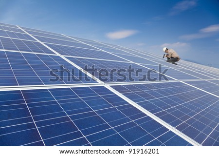 close up solar panel and professional worker installing photovoltaic solar panels