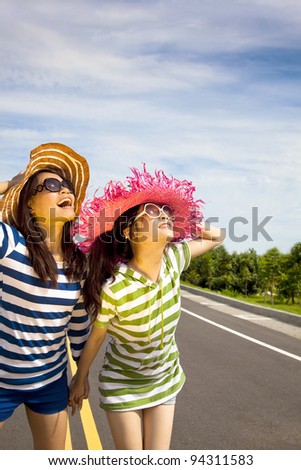 happy girls watching the sky and enjoy summer vocation