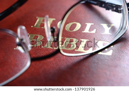 Holy Bible, Eye Glasses A photo of a bible, eye glasses.