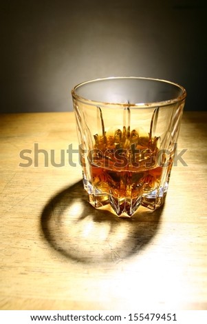 Alcoholic Drink in a Glass A photo of an alcoholic drink or liquor in a glass and on a table