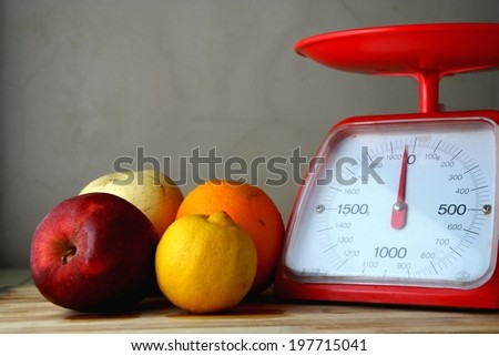 Fresh fruits and a weighing scale Photo of fresh fruits and a weighing scale